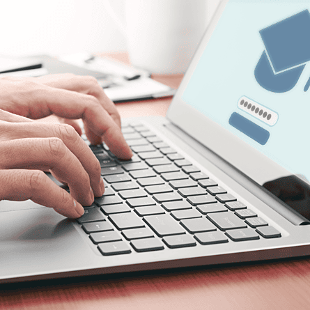 Hands typing on laptop keyboard signing into online membership